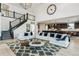 Spacious living room with high ceilings, staircase, and open access to the kitchen at 303 Rogers Ct, Castle Rock, CO 80104