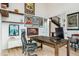 Bright home office with ample wall decor, shelving, a wooden desk, and French doors leading to the foyer at 303 Rogers Ct, Castle Rock, CO 80104