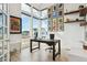 Home office featuring large windows, a dark wood desk, and a gallery wall with framed artwork at 303 Rogers Ct, Castle Rock, CO 80104