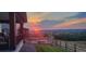 Scenic sunset view from the backyard featuring a patio, wood fence, and landscaped yard at 303 Rogers Ct, Castle Rock, CO 80104