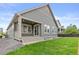 A home's exterior featuring a gray siding, covered patio and green backyard with a beautiful grass lawn at 757 Cabot Dr, Erie, CO 80516