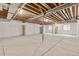 Unfinished basement with concrete floor, exposed ceiling and support beams offering customizable space at 757 Cabot Dr, Erie, CO 80516