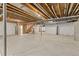 Unfinished basement area showing a concrete floor, exposed ceiling and utility access, ready to be personalized at 757 Cabot Dr, Erie, CO 80516