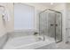 Bathroom showcasing a soaking tub and glass-enclosed shower at 757 Cabot Dr, Erie, CO 80516