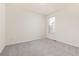 A bright bedroom featuring neutral walls and carpet, complete with a window for natural light at 757 Cabot Dr, Erie, CO 80516