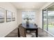 Bright dining room with a modern table setting and access to the outdoor deck at 757 Cabot Dr, Erie, CO 80516
