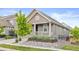 Charming home with a covered porch and rock garden at 757 Cabot Dr, Erie, CO 80516