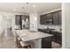 Kitchen featuring granite countertops, an island with seating, and stainless steel appliances at 757 Cabot Dr, Erie, CO 80516