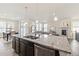 Open-concept kitchen boasts a large island with granite countertops and stainless steel appliances at 757 Cabot Dr, Erie, CO 80516
