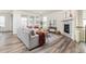 Bright living room featuring a fireplace, modern decor, and wood floors at 757 Cabot Dr, Erie, CO 80516
