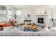 Cozy living room with fireplace, large windows, and stylish decor at 757 Cabot Dr, Erie, CO 80516