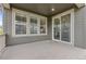 A covered back patio with plank decking, large windows and sliding glass doors offering outdoor relaxation at 757 Cabot Dr, Erie, CO 80516