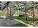 Relaxing backyard area features mature trees, lawn, and a patio with wrought iron furniture at 1172 Juniper Ave, Boulder, CO 80304