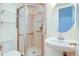 Bathroom with glass-enclosed shower, pedestal sink, and mirrored medicine cabinet at 1172 Juniper Ave, Boulder, CO 80304