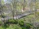 View of a bridge in the community surrounded by lush greenery and mature trees at 1172 Juniper Ave, Boulder, CO 80304