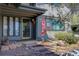 Charming home entrance featuring a 'For Sale' sign, gray siding, stone steps, and manicured landscaping at 1172 Juniper Ave, Boulder, CO 80304