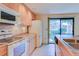 Kitchen with wood cabinets, appliances, and sliding glass doors offering backyard views at 1172 Juniper Ave, Boulder, CO 80304