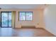 Sunny living room featuring wood floors, large windows, and sliding glass doors to outdoor space at 1172 Juniper Ave, Boulder, CO 80304