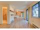 Open living area with wood floors, adjacent kitchen, and access to bathroom with glass shower at 1172 Juniper Ave, Boulder, CO 80304