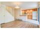 Living area with wood flooring, staircase, and adjacent kitchen with wood cabinets at 1172 Juniper Ave, Boulder, CO 80304