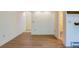 Bright, open living area with wood floors leading to hallway, door, and bathroom at 1172 Juniper Ave, Boulder, CO 80304