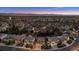 Dusk aerial view of a suburban neighborhood with mountain views in the background at 10969 Valleybrook Cir, Highlands Ranch, CO 80130