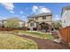 Well-maintained backyard featuring a covered patio and a lush green lawn at 10969 Valleybrook Cir, Highlands Ranch, CO 80130
