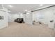 Open basement design with comfortable seating area, recessed lighting, and a sliding barn door at 10969 Valleybrook Cir, Highlands Ranch, CO 80130