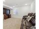Cozy basement showcasing a large television, media cabinet, and comfortable leather seating at 10969 Valleybrook Cir, Highlands Ranch, CO 80130