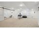 Spacious basement area featuring recessed lighting, large windows, desk, and a unique sliding barn door at 10969 Valleybrook Cir, Highlands Ranch, CO 80130