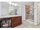 Bathroom featuring a glass shower, vanity with ample storage and neutral tiling at 10969 Valleybrook Cir, Highlands Ranch, CO 80130