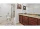 Bathroom featuring a walk-in shower with tile surround, granite countertop, and modern fixtures at 10969 Valleybrook Cir, Highlands Ranch, CO 80130