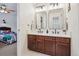Bathroom with double sinks, dark wood cabinets, and bright lighting at 10969 Valleybrook Cir, Highlands Ranch, CO 80130