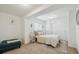 Charming bedroom with a tufted headboard, neutral bedding, and ample closet space at 10969 Valleybrook Cir, Highlands Ranch, CO 80130