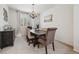 Stylish dining room with a rustic wood table, chandelier, and plantation shutters at 10969 Valleybrook Cir, Highlands Ranch, CO 80130