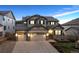 Charming two-story home featuring a three-car garage, stone accents, and a welcoming front entrance at 10969 Valleybrook Cir, Highlands Ranch, CO 80130