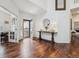 Bright and airy foyer with hardwood floors, a decorative table, and an open view of the home's interior at 10969 Valleybrook Cir, Highlands Ranch, CO 80130
