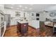 Open-concept kitchen featuring white cabinets, a center island, and hardwood floors at 10969 Valleybrook Cir, Highlands Ranch, CO 80130