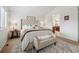 Bright main bedroom features a tufted headboard, decorative pillows and a cozy bench at 10969 Valleybrook Cir, Highlands Ranch, CO 80130