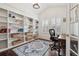 Cozy office with custom built-in bookshelves, natural light, and a comfortable workspace at 10969 Valleybrook Cir, Highlands Ranch, CO 80130