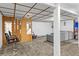 Spacious finished basement area with chair, mirrors, and wooden panel wall, perfect for a salon or flex space at 1732 Lansing St, Aurora, CO 80010