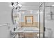 Bright bathroom with separate tub and shower, vanity, and updated fixtures at 1732 Lansing St, Aurora, CO 80010