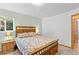 Bedroom with classic wood bed frame, side tables and green accent wall at 1732 Lansing St, Aurora, CO 80010