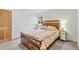 Comfortable bedroom with wood accents, floral bedding, and ample natural light at 1732 Lansing St, Aurora, CO 80010