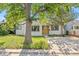 Charming single-Gathering home featuring a wood accent front door, landscaped yard, and a concrete driveway at 1732 Lansing St, Aurora, CO 80010