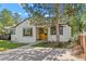Charming single-Gathering home featuring a wood accent front door, landscaped yard, and a concrete driveway at 1732 Lansing St, Aurora, CO 80010