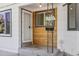 Charming wood accent front porch and entrance to the home, with a mailbox on the porch at 1732 Lansing St, Aurora, CO 80010