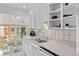 Sunlit kitchen with white cabinetry, stainless steel sink, and a view into the dining area at 1732 Lansing St, Aurora, CO 80010