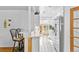 Bright kitchen features white cabinetry, breakfast bar seating, stainless steel appliances, and tiled floors at 1732 Lansing St, Aurora, CO 80010