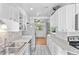 Bright kitchen features stainless steel appliances, white cabinets, and plenty of counter space at 1732 Lansing St, Aurora, CO 80010